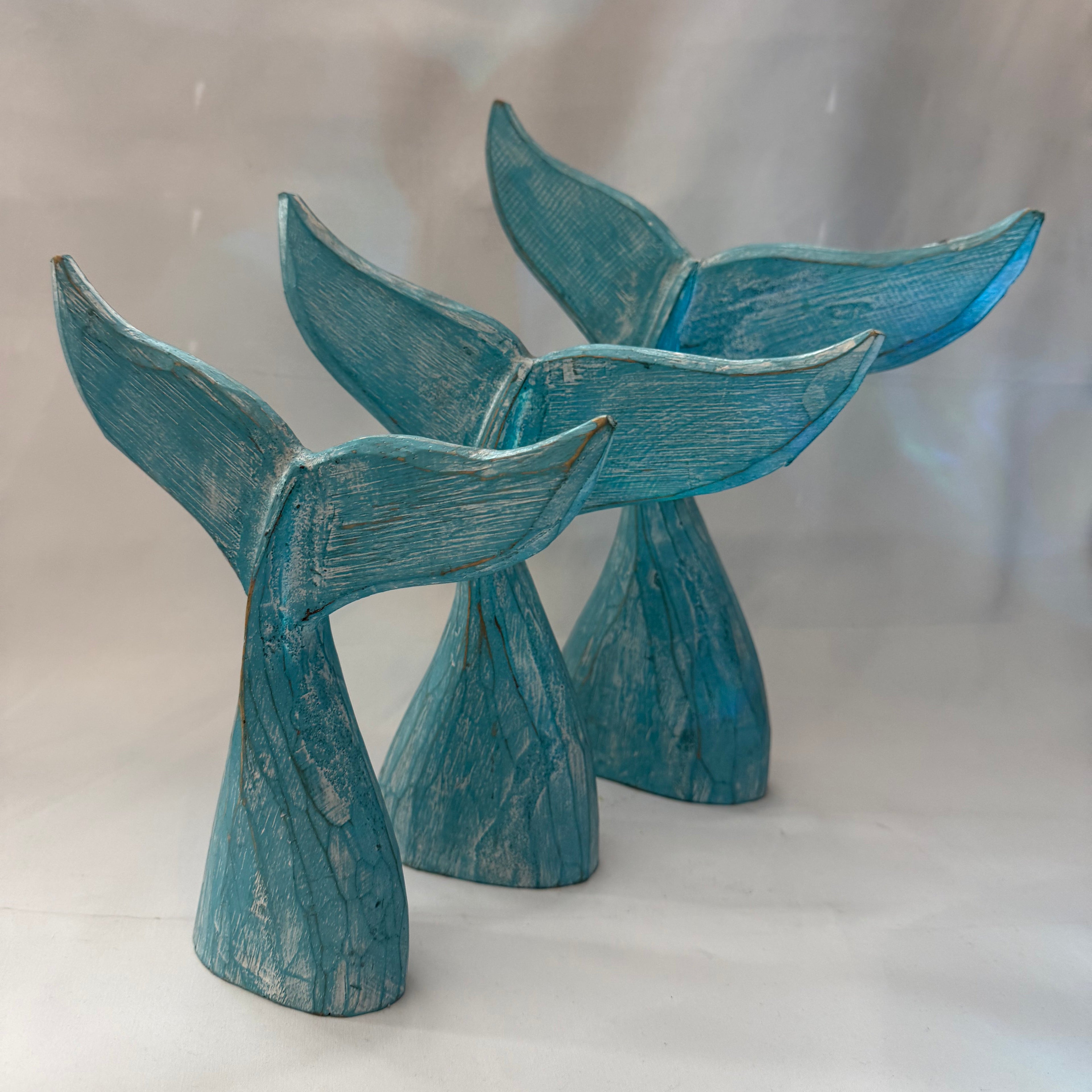 Blue ceramic fish-shaped objects on a white background